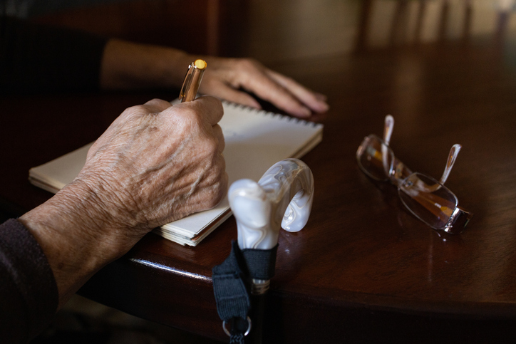 elderly woman writing a letter